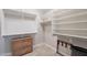 Walk-in closet with custom shelving, drawers, and rods; tiled floor and neutral paint colors at 2 W Pasture Canyon Dr, San Tan Valley, AZ 85143