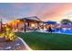 Expansive backyard featuring a pool, lush artificial grass, and an outdoor entertainment area at 2024 E Cherry Hills Pl, Chandler, AZ 85249