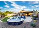 Gorgeous backyard with a pool, spa, travertine deck, and lush landscaping for a relaxing outdoor space at 2024 E Cherry Hills Pl, Chandler, AZ 85249