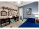 Spacious bedroom with a desk, ceiling fan, blue accent wall, shelves, and carpet flooring at 2024 E Cherry Hills Pl, Chandler, AZ 85249