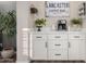 Charming coffee bar area with white cabinets, quartz countertop, decorative sign and stainless-steel coffee maker at 2024 E Cherry Hills Pl, Chandler, AZ 85249