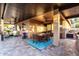 Inviting covered patio features a dining table, fan, and ample seating area with travertine flooring at 2024 E Cherry Hills Pl, Chandler, AZ 85249