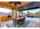 Covered patio with an outdoor kitchen and dining area, leading to a pool with lounge chairs at 2024 E Cherry Hills Pl, Chandler, AZ 85249