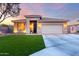 Charming single-story home featuring a manicured lawn, stone accents, and a two-car garage at 2024 E Cherry Hills Pl, Chandler, AZ 85249