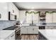 Well-equipped kitchen featuring white cabinets, stainless steel appliances, and a blue backsplash at 2024 E Cherry Hills Pl, Chandler, AZ 85249