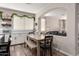 Bright kitchen with white cabinets, wooden dining table with bench, and seamless connection to the living space at 2024 E Cherry Hills Pl, Chandler, AZ 85249