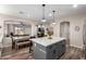 Stylish open kitchen with a gray island, dining table, and open access to the living area at 2024 E Cherry Hills Pl, Chandler, AZ 85249