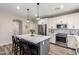 Modern kitchen with white cabinetry, stainless steel appliances, and an island with bar seating at 2024 E Cherry Hills Pl, Chandler, AZ 85249