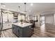 Spacious kitchen with a gray island, white cabinets, and an open layout leading to the dining area at 2024 E Cherry Hills Pl, Chandler, AZ 85249