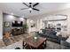 Open-concept living room with wood-look flooring, ceiling fan, and a view of the kitchen at 2024 E Cherry Hills Pl, Chandler, AZ 85249