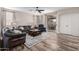 Bright living room showcasing hardwood floors, a ceiling fan, and sliding glass doors to the backyard at 2024 E Cherry Hills Pl, Chandler, AZ 85249