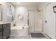 Main bathroom featuring a soaking tub, glass-enclosed shower, tile floors and gray vanity at 2024 E Cherry Hills Pl, Chandler, AZ 85249