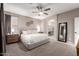 Relaxing main bedroom featuring plush carpet, ceiling fan, a dresser and access to the bathroom at 2024 E Cherry Hills Pl, Chandler, AZ 85249