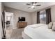 Calming main bedroom with soft carpet, ceiling fan, dresser, TV and adjoining main bathroom at 2024 E Cherry Hills Pl, Chandler, AZ 85249