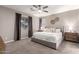 Inviting main bedroom showcasing plush carpet, ceiling fan, a dresser and access to the bathroom at 2024 E Cherry Hills Pl, Chandler, AZ 85249