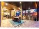 Covered outdoor dining and entertaining area that features a large grill, fan, and adjacent to the outdoor pool area at 2024 E Cherry Hills Pl, Chandler, AZ 85249