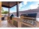 Well-equipped outdoor kitchen with stainless steel grill and appliances, perfect for entertaining at 2024 E Cherry Hills Pl, Chandler, AZ 85249