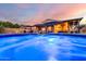 Enjoy this pool view from the water featuring seating, a covered patio with a grill, landscaping, and a privacy fence at 2024 E Cherry Hills Pl, Chandler, AZ 85249
