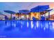 Inviting backyard pool with lounge chairs and umbrellas under a beautiful dusk sky at 2024 E Cherry Hills Pl, Chandler, AZ 85249