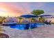Sparkling pool and spa with a patio and lounge chairs, landscaping, and beautiful evening sky, great for relaxation and entertaining at 2024 E Cherry Hills Pl, Chandler, AZ 85249
