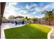 Lush backyard features a pool, patio, and green turf, creating a perfect oasis at 2024 E Cherry Hills Pl, Chandler, AZ 85249