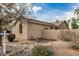 View of the home's backyard showcasing the stucco exterior and low maintenance desert landscaping at 2112 E Yellowstone Pl Pl, Chandler, AZ 85249