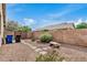 Low-maintenance backyard featuring desert landscaping, block-wall fencing, and a view of the home's exterior at 2112 E Yellowstone Pl Pl, Chandler, AZ 85249