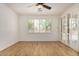 Bright bedroom with wood floors, shutters on the windows, and access to a sliding glass door at 2112 E Yellowstone Pl Pl, Chandler, AZ 85249