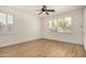 Spacious bedroom featuring wood-style floors, white walls, and light-filled windows with shutters at 2112 E Yellowstone Pl Pl, Chandler, AZ 85249