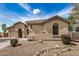 Charming single-story home with stucco exterior, tiled roof, and desert landscaping under a blue sky at 2112 E Yellowstone Pl Pl, Chandler, AZ 85249