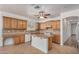 Bright kitchen with wood cabinets, stainless appliances, tile floors and a kitchen island at 2112 E Yellowstone Pl Pl, Chandler, AZ 85249