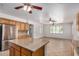 Spacious kitchen features an island, stainless steel appliances, and tile flooring with an open layout at 2112 E Yellowstone Pl Pl, Chandler, AZ 85249