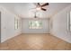 Bright room with tile floors, ceiling fans, and plantation shutters on the windows at 2112 E Yellowstone Pl Pl, Chandler, AZ 85249
