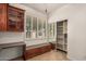 Office area with custom wood cabinets, window with shutters, and built-in bench with storage at 2112 E Yellowstone Pl Pl, Chandler, AZ 85249
