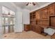 Open office space featuring custom wood cabinets, built-in desk, and a tile floor at 2112 E Yellowstone Pl Pl, Chandler, AZ 85249