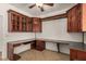 Office space with custom wood cabinets, granite counters, under cabinet lighting, and tile floors at 2112 E Yellowstone Pl Pl, Chandler, AZ 85249