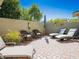 Private backyard patio with lounge chairs, dining area and desert landscaping at 21134 W Green St, Buckeye, AZ 85396