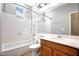 Bright bathroom with a shower-tub combo, ample counter space, and a large mirror at 21134 W Green St, Buckeye, AZ 85396