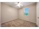 Neutral bedroom featuring soft carpet, a ceiling fan, and a window offering natural light at 21134 W Green St, Buckeye, AZ 85396