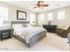 Bedroom with a ceiling fan, window, bed, dresser, and accent chair at 21134 W Green St, Buckeye, AZ 85396