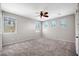 A spacious neutral bedroom with carpeted floors and natural light from multiple windows at 21134 W Green St, Buckeye, AZ 85396
