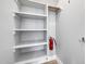 Bright, organized closet with built-in shelves and a hanging rod, offering ample storage solutions at 21134 W Green St, Buckeye, AZ 85396