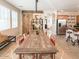Open dining room featuring a large wooden table, modern lighting, sliding barn door, and stainless steel appliances at 21134 W Green St, Buckeye, AZ 85396