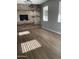 Dining room has wood-look floors, a brick accent wall with a fireplace, and ample natural light at 21134 W Green St, Buckeye, AZ 85396