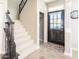 Stairway and entryway with black door and modern rustic decorations at 21134 W Green St, Buckeye, AZ 85396