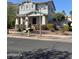 Inviting home with a covered porch, landscaped flower beds, and a well-manicured front yard at 21134 W Green St, Buckeye, AZ 85396