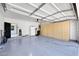 Spacious garage with storage cabinets, epoxy flooring, and direct access to the home at 21134 W Green St, Buckeye, AZ 85396