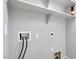 Functional laundry room with shelving and utility connections at 21134 W Green St, Buckeye, AZ 85396