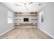 Bright room with wood floors, custom shelves, and inviting ambiance with lots of natural light at 21134 W Green St, Buckeye, AZ 85396