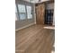 The open-concept dining room has wood-look flooring, a barn door, and industrial lighting at 21134 W Green St, Buckeye, AZ 85396